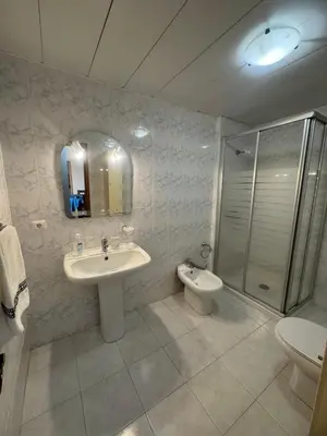 a bathroom with a sink and a shower and a toilet at Ajuda Mar Holidays in Funchal