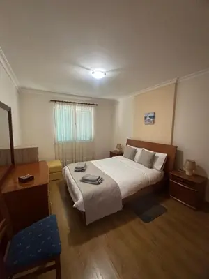 a hotel room with a bed and a chair at Ajuda Mar Holidays in Funchal