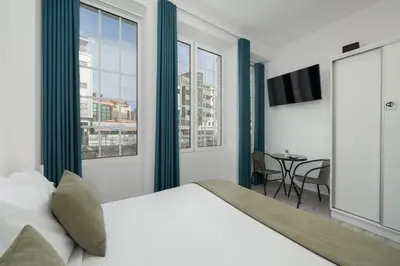 a bedroom with a large bed and a table at Residência Lord Freitas I by An Island Apart in Funchal