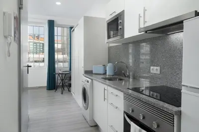 a white kitchen with a sink and a dishwasher at Residência Lord Freitas I by An Island Apart in Funchal