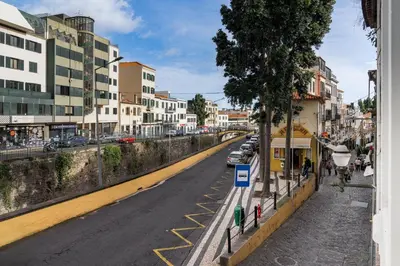 a city street with cars parked on the side of the road at Residência Lord Freitas I by An Island Apart in Funchal