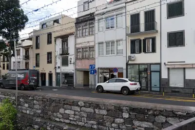 a white car parked on a city street with buildings at Residência Lord Freitas I by An Island Apart in Funchal