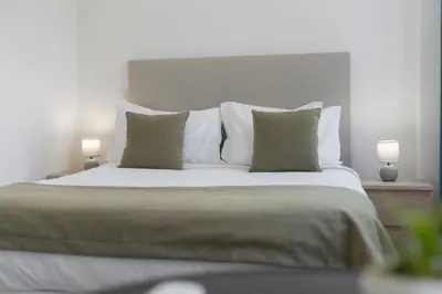 a bedroom with a large bed with two lamps at Residência Lord Freitas I by An Island Apart in Funchal