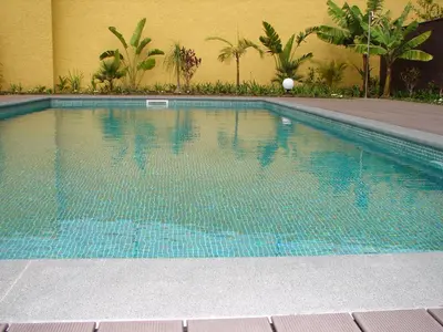 a swimming pool with blue water in front of a building at Funchal bay incredible view with pool in Funchal