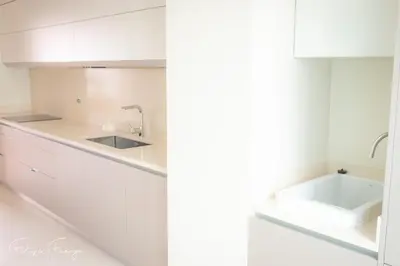 a kitchen with white cabinets and a sink at Funchal bay incredible view with pool in Funchal