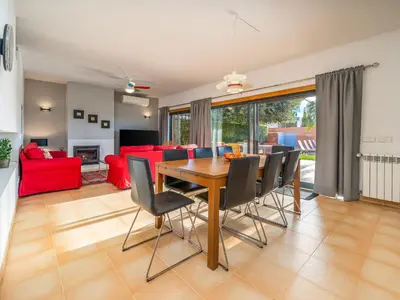 a dining room and living room with a wooden table and chairs at Contemporary villa with private pool #1987 in Lagos