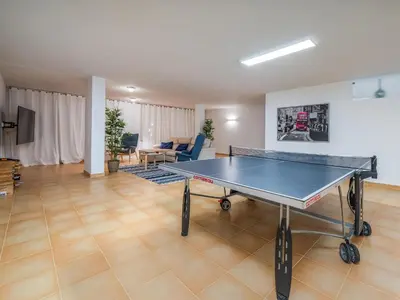a ping pong table in a living room at Contemporary villa with private pool #1987 in Lagos