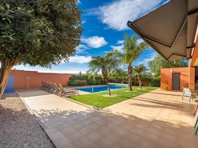 a villa with a swimming pool and palm trees at Contemporary villa with private pool #1987 in Lagos