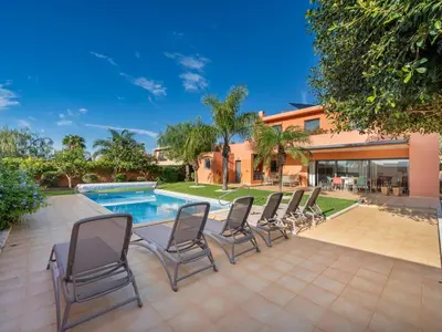 a group of chairs sitting next to a swimming pool at Contemporary villa with private pool #1987 in Lagos