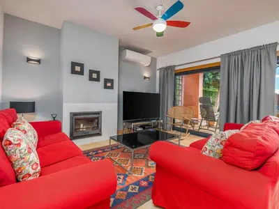 a living room with two red couches and a tv at Contemporary villa with private pool #1987 in Lagos