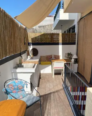 a balcony with a sink and a table at Mango Tree House Funchal Madeira Island in Funchal