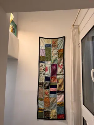 a quilt hanging on a wall next to a window at Mango Tree House Funchal Madeira Island in Funchal