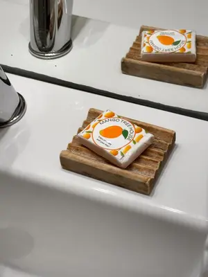 two slices of cheese on cutting boards on a counter at Mango Tree House Funchal Madeira Island in Funchal