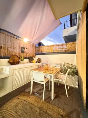 a kitchen with a table and chairs on a patio at Mango Tree House Funchal Madeira Island in Funchal