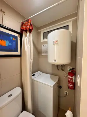 a small bathroom with a toilet and a light at Mango Tree House Funchal Madeira Island in Funchal