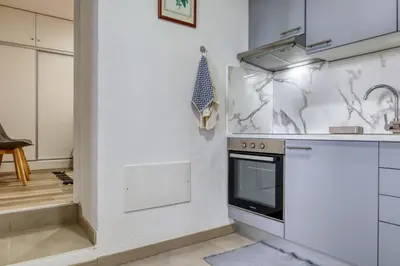 a kitchen with a stove and a sink at Funchal Hills, a Home in Madeira in Funchal