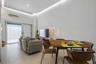 a living room with a dining room table and chairs at Studio Palace B by Homie in Funchal