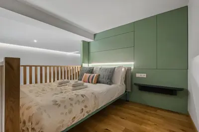 a bedroom with a bed with a green headboard at Studio Palace B by Homie in Funchal