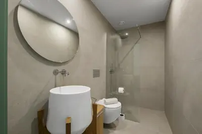 a bathroom with a sink and a toilet and a mirror at Studio Palace A by Homie in Funchal