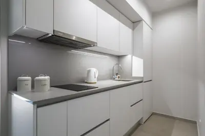 a kitchen with white cabinets and a sink at Studio Palace A by Homie in Funchal
