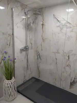 a bathroom with a shower and a vase with purple flowers at Enchanting and cozy ACHADA PALACE APARTMENT in Funchal