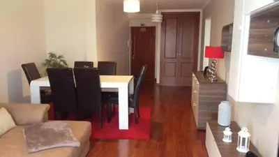 a living room with a dining room table with black chairs at Enchanting and cozy ACHADA PALACE APARTMENT in Funchal