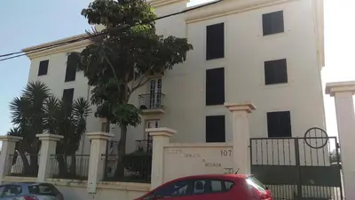 a red car parked in front of a white building at Enchanting and cozy ACHADA PALACE APARTMENT in Funchal