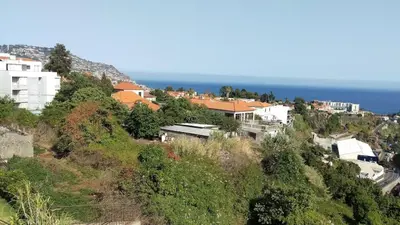 a group of buildings on a hill near the ocean at Enchanting and cozy ACHADA PALACE APARTMENT in Funchal