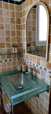 a bathroom with a green sink and a mirror at Villa Ocean Wave Calheta - Oversized Pool & Stunning Ocean Views in Calheta