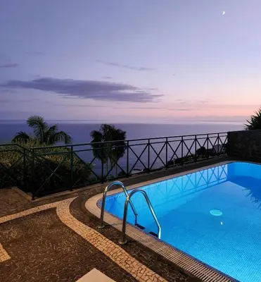 a swimming pool with the ocean in the background at Villa Ocean Wave Calheta - Oversized Pool & Stunning Ocean Views in Calheta
