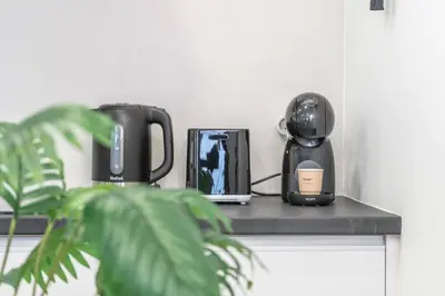 a counter with two coffee makers and a plant on it at A View to Paradise – Spectacular Sea & Bay Views in Funchal