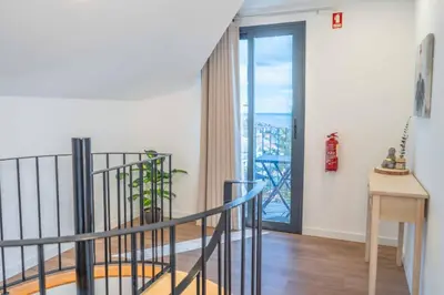 two beds in a room with yellow and white at A View to Paradise – Spectacular Sea & Bay Views in Funchal
