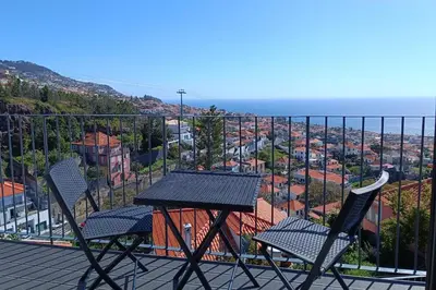 a bedroom with a large window with a view at A View to Paradise – Spectacular Sea & Bay Views in Funchal