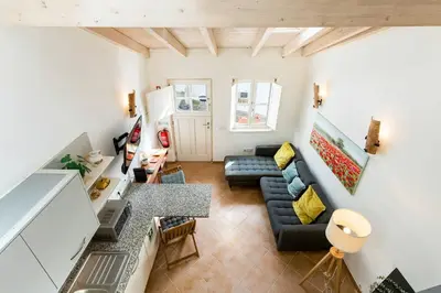 a living room with a couch and a table at Raposeira Cottage in Sagres