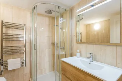 a bathroom with a sink and a shower at Raposeira Cottage in Sagres