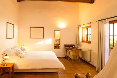 a bedroom with a bed and a desk in a room at Atrio in Estreito da Calheta
