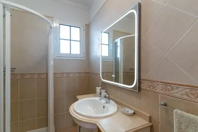 a bathroom with a sink and a mirror at Casa Do Dino in Ribeira Brava