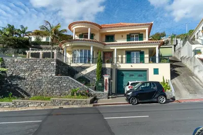 a small car parked in front of a house at Casa Do Dino in Ribeira Brava