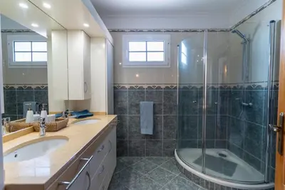 a bathroom with a shower and a sink and a tub at Casa Do Dino in Ribeira Brava