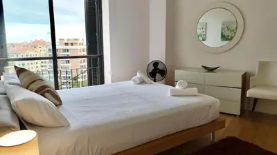 a bedroom with a large white bed with a window at Forum Sky in Funchal