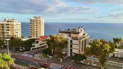a bedroom with a large bed and a mirror at Forum Sky in Funchal