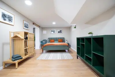 a bedroom with a bed and a green cabinet at CITY OASlS FUNCHAL APARTMENT & STUDIO in Funchal