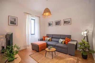 a living room with a couch and a tv at CITY OASlS FUNCHAL APARTMENT & STUDIO in Funchal
