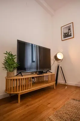 a large flat screen tv sitting on top of a table at CITY OASlS FUNCHAL APARTMENT & STUDIO in Funchal