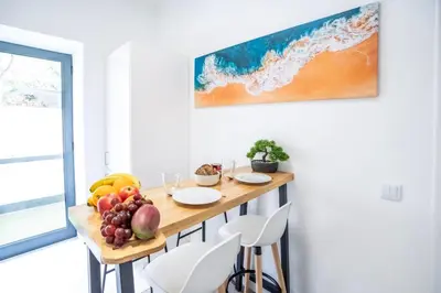 a kitchen with a table with fruit on it at CITY OASlS FUNCHAL APARTMENT & STUDIO in Funchal