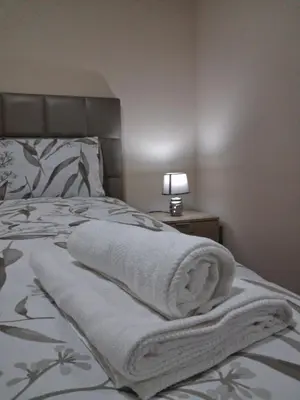 a bedroom with a bed with towels on it at Arco-Íris in Ponta do Sol