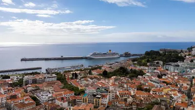 a bedroom with a bed and a large window at Funcho 91, cozy apartment in the heart of the city in Funchal