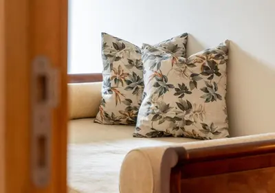 a bed with two pillows in a room at Funcho 91, cozy apartment in the heart of the city in Funchal