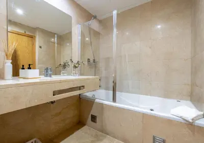 a bedroom with a bed and a lamp on a table at Funcho 91, cozy apartment in the heart of the city in Funchal