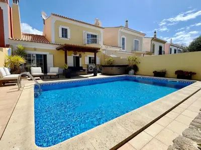 a swimming pool in front of a house at V4 moderno com Piscina - Burgau in Burgau